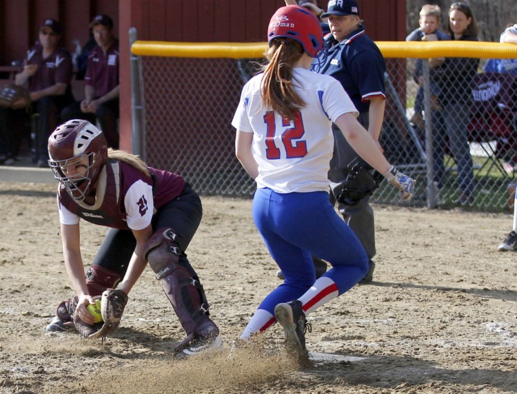 Oak Hill sophomore Sadie Waterman beats the throw at home to score a run for the Raiders in a Mountain Valley Conference softball game Monday against Monmouth Academy.