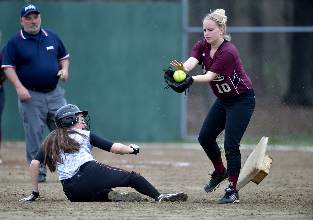 Winslow's Alexa Petrovic slides safely into second base as Nokomis' Hanna Meservey (10) waits for the throw Thursday in Winslow.