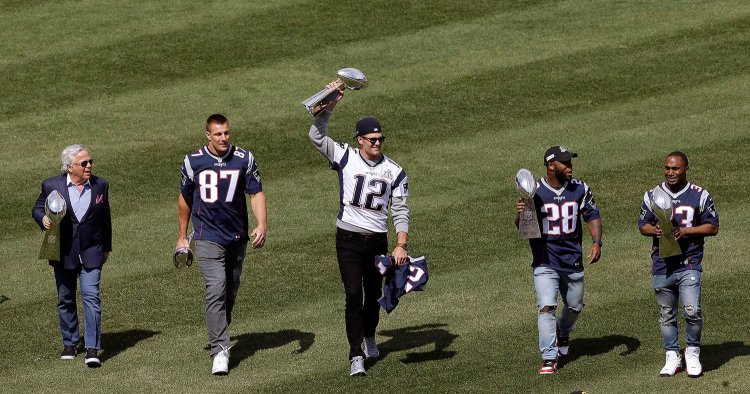 New England Patriots owner Robert Kraft, and players Rob Gronkowski, Tom Brady, James White and Dion Lewis display the team's five Super Bowl trophies before the Red Sox opening day game on April 3.