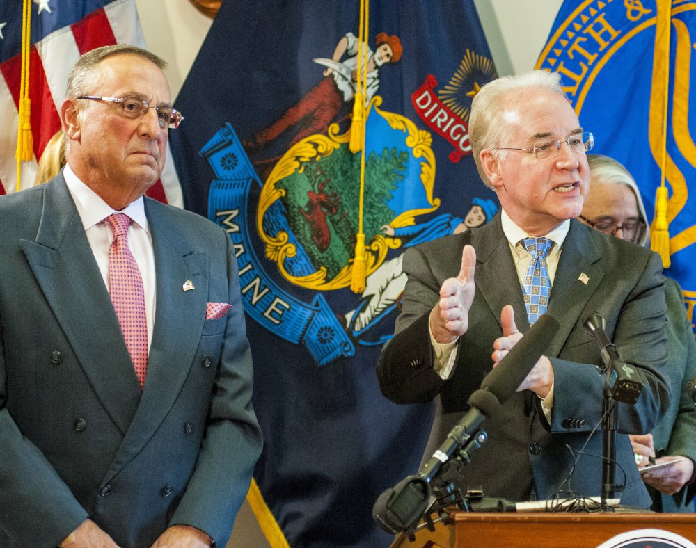 Gov. Paul LePage, left, listens as U.S. Health and Human Services Secretary Tom Price answers a reporter's question at the State House in Augusta.