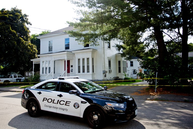  A police cruiser passes by 19 Western Ave. in Biddeford in July 2014, a day after two men were fatally shot there.