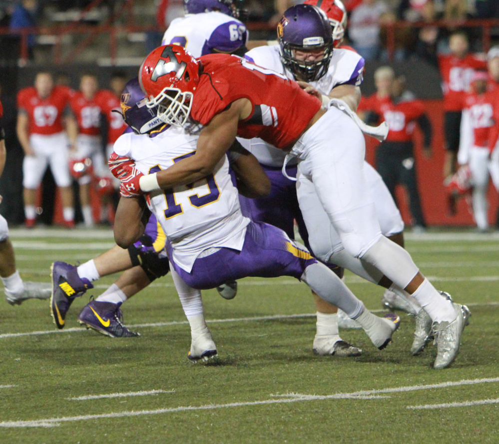 Derek Rivers, right, wraps up Northern Iowa quarterback Aaron Bailey during a game last season.