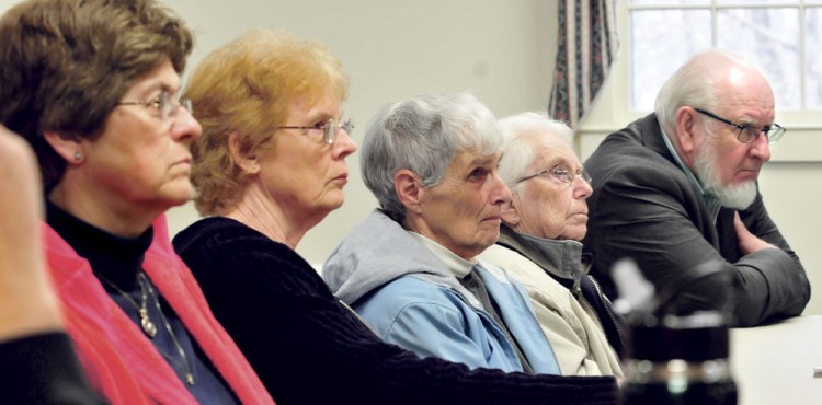 A group of people attending a personal security seminar, including the Rev. Ronald Morrell Sr., of China Baptist Church, right, listen to Andrew Grover, of Bangor Savings Bank, deliver a talk about protecting personal identity and money during a seminar Tuesday in China.