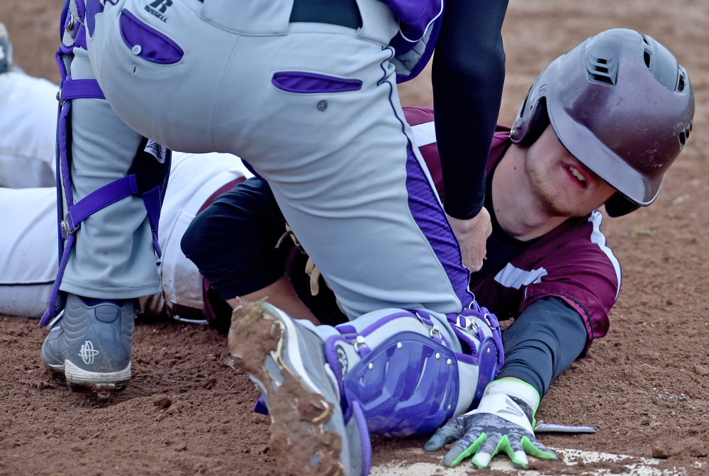 Waterville catcher Justin Wentworth tags out Nokomis' Alex Baird during a Kennebec Valley Athletic Conference Class B game last season in Waterville.