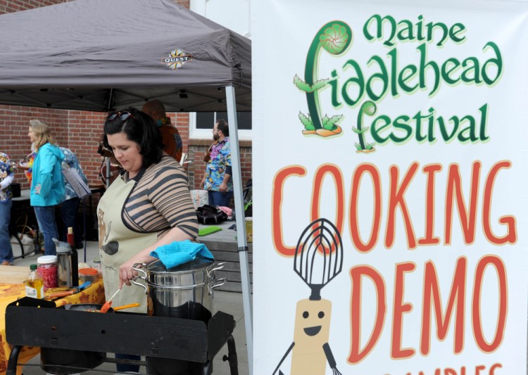 Ashley Montgomery prepares a dish of lobster mushrooms and fiddleheads over linguini on May 7, 2016, at the annual Maine Fiddlehead Festival at the University of Maine in Farmington.