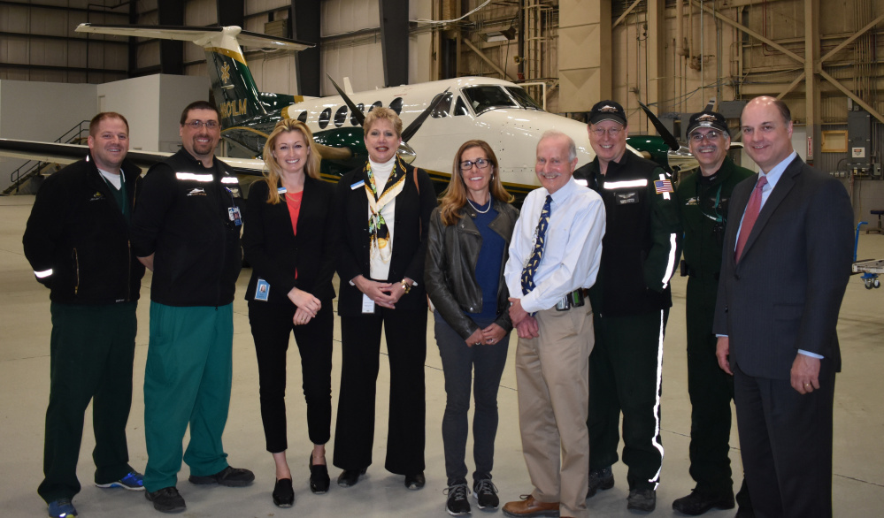 LifeFlight crew members gave Camden National Bank employees a tour of the LifeFlight hangar in April at Bangor International Airport. From left are Chuck Hogan, flight nurse, Bangor base manager, LifeFlight; Brent Watson, flight nurse, LifeFlight; Jody Landrith, banking center manager, Camden National Bank; Vera Roberts, commercial regional manager, Camden National Bank; Amy Root, director of development, LifeFlight Foundation; Dr. Norm Dinerman, medical director, LifeFlight; Hargrave Garrison, fixed-wing pilot, LifeFlight; Jim Gerry, fixed-wing pilot, LifeFlight; and Greg Dufour, president and CEO, Camden National Bank.