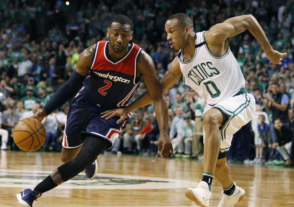 Washington star John Wall, left, drives against Boston Celtics guard Avery Bradley during the third quarter of Game 1 of a second-round series on April 30.