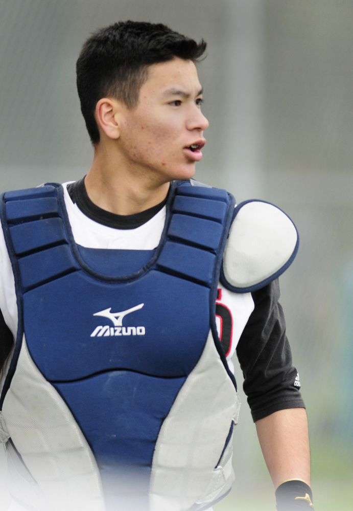 Hall-Dale catcher Akira Warren talks to teammates between innings during a game on Tuesday against Bridgeway in Farmingdale.