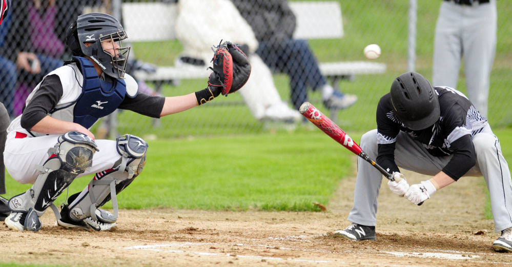Hall-Dale catcher Akira Warren catches a high inside pitch as a Bridgeway batter ducks during a game on Tuesday at Hall-Dale High School in Farmingdale.