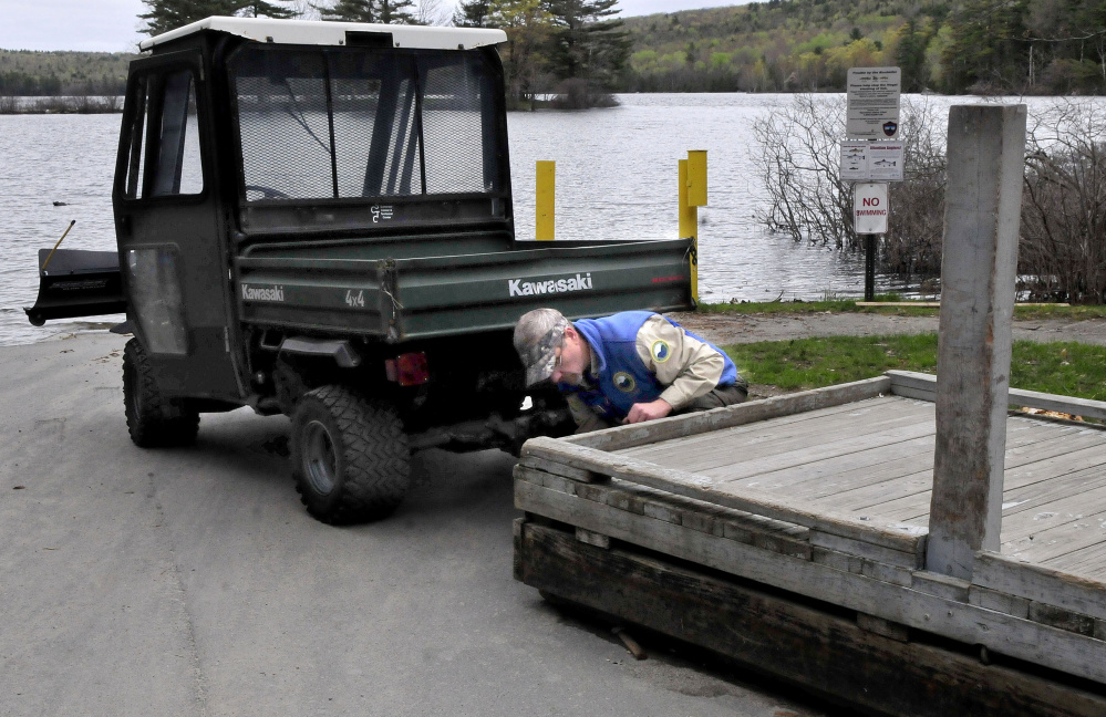Derek Ellis, Lake George Regional Park resource manager, uses the new all terrain vehicle on Thursday to line up a dock that will be moved into the lake at the boat launch on the Canaan side of the park. The work vehicle was donated by the Somerset County Sheriff's Office.