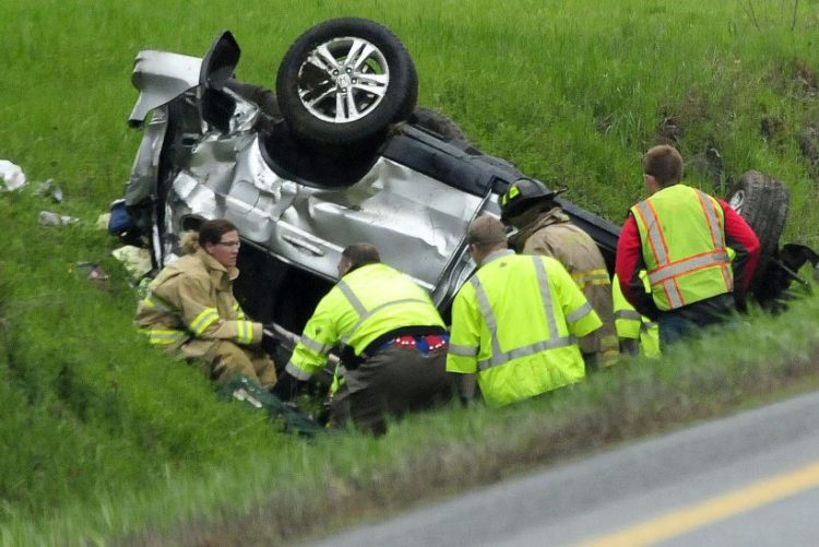Firefighters and rescue personnel extricate the occupant of this vehicle that went off the northbound lane of Interstate 95 in Benton and went airborne before overturning on Monday. Officials say the crash was fatal, and there were no passengers in the vehicle.