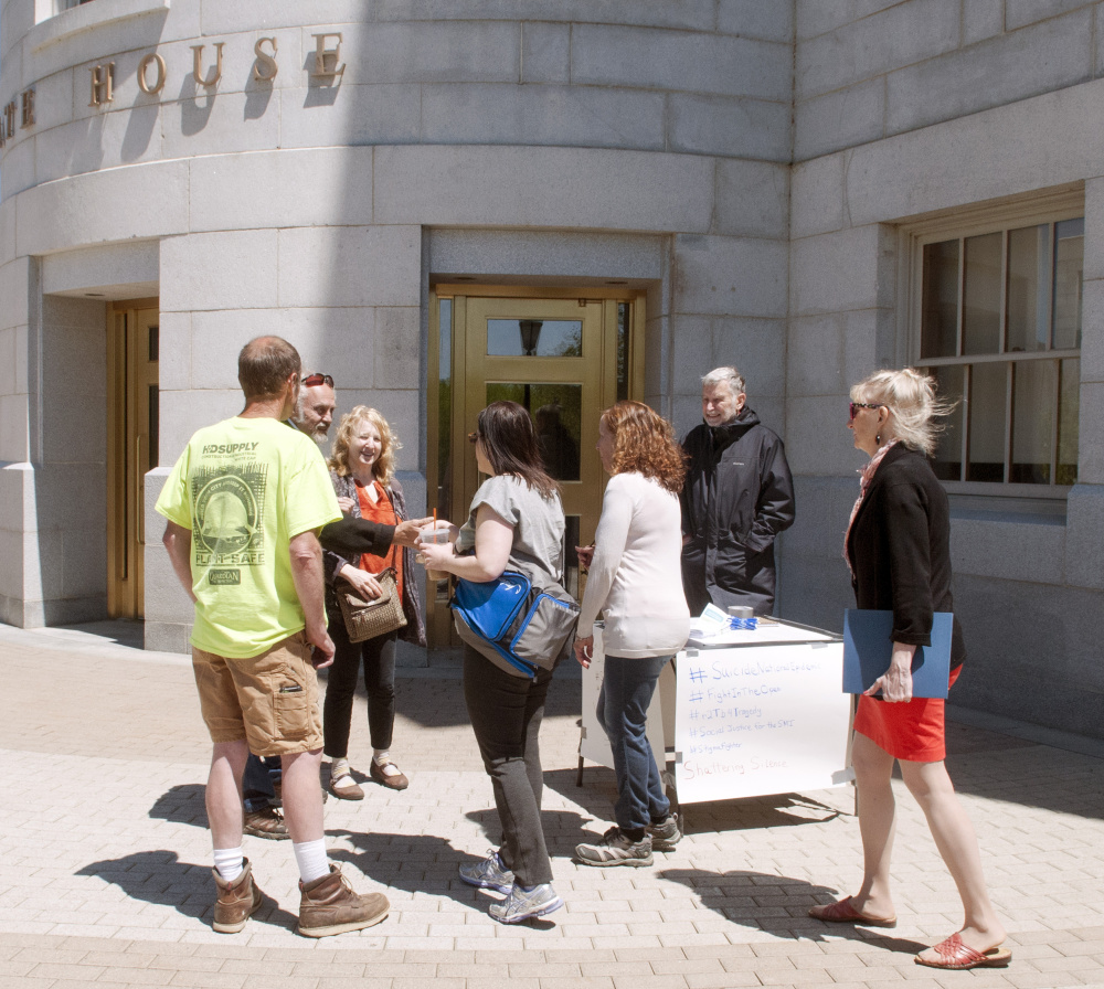 People meet and greet each other at the Families of Treatment of Serious Mental Illness (TreatSMI) first Shattering Silence March on Saturday at the Maine State House in Augusta.