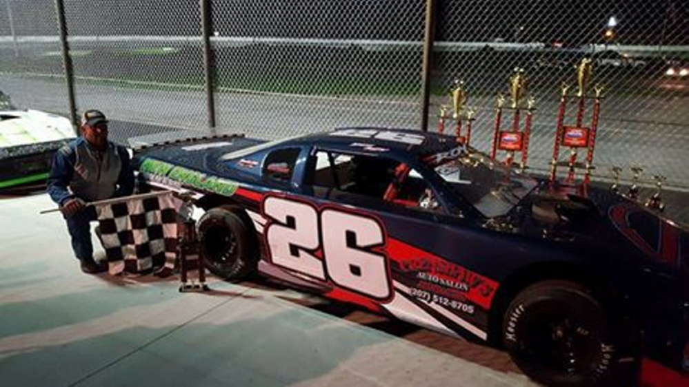 Vasselboro's Brent Roy kneels next to his car after winning last weekend's Outlaw Mini Stock feature. It was the 34th win of Roy's career, and 10 years removed from his previous victory.