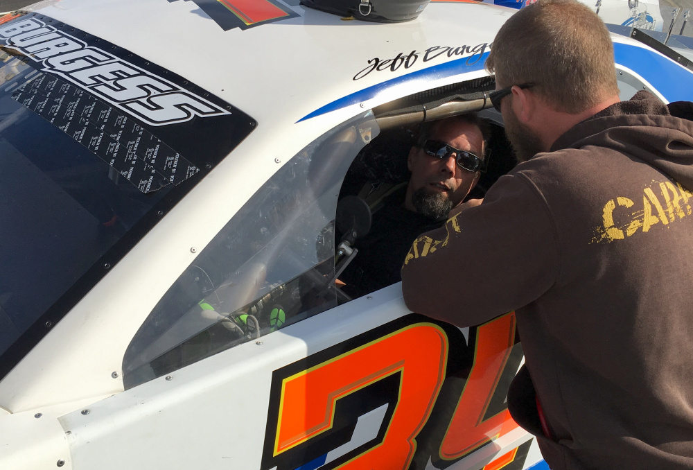 Staff photo by Travis Barrett 
 Jeff Burgess of East Madison gets buckled into his car prior to the start of the Coastal 200 on Sunday at Wiscasset Speedway.