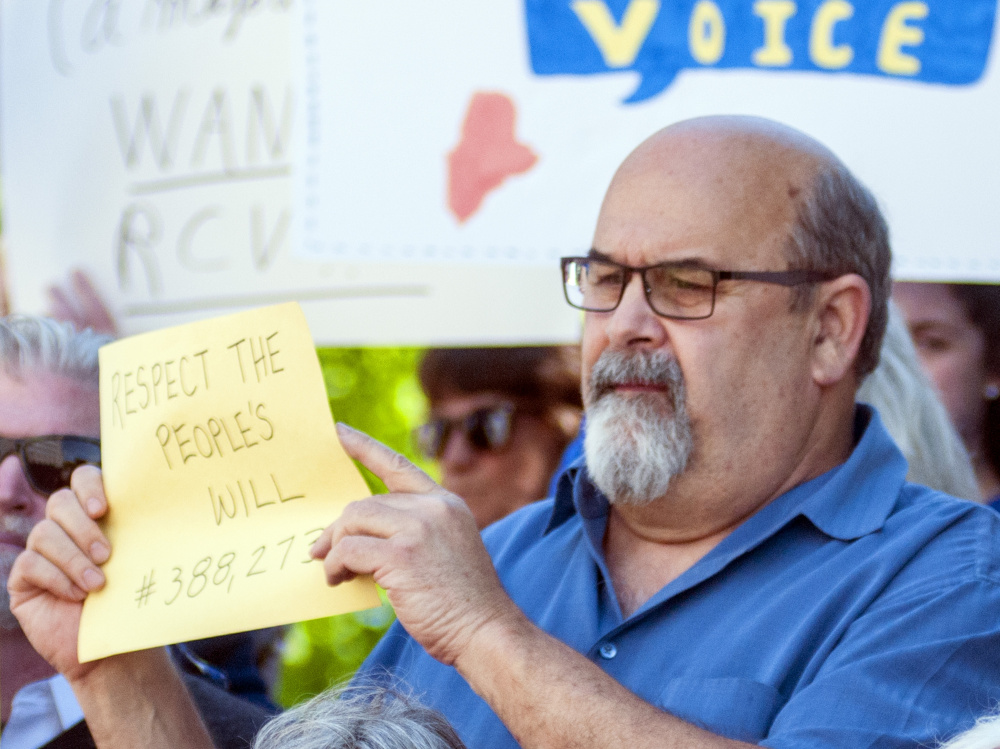 Augusta Mayor David Rollins displays the number of Mainers – 388,273 – who voted in November for the switch to ranked-choice voting in Maine elections for governor, the Legislature and Congress.