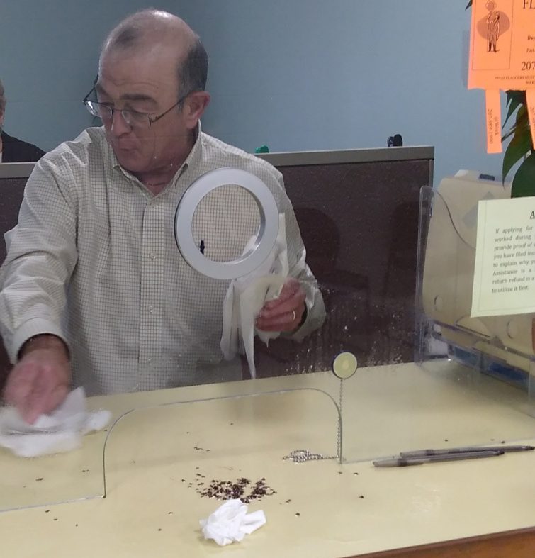 Ralph St. Pierre, Augusta's finance director and assistant city manager, picks up bedbugs that a disgruntled visitor reportedly unleashed Friday afternoon at Augusta City Center.