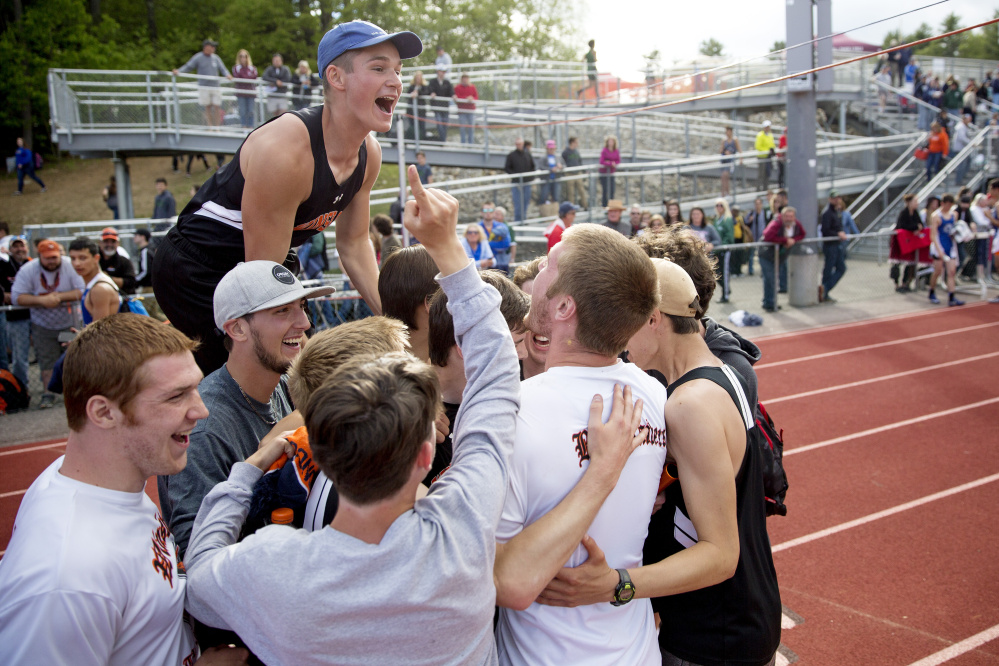 Winslow High School student celebrate after the boys track and field team won the Class B state championship Saturday at Yarmouth High School.