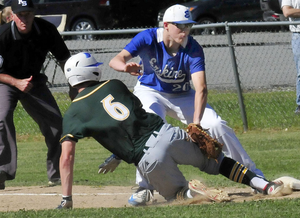 Erskine's Noah Bonsant tags out Mt. Desert Island runner Jacob Mitchell during a Class B North quarterfinal game last spring in South China.
