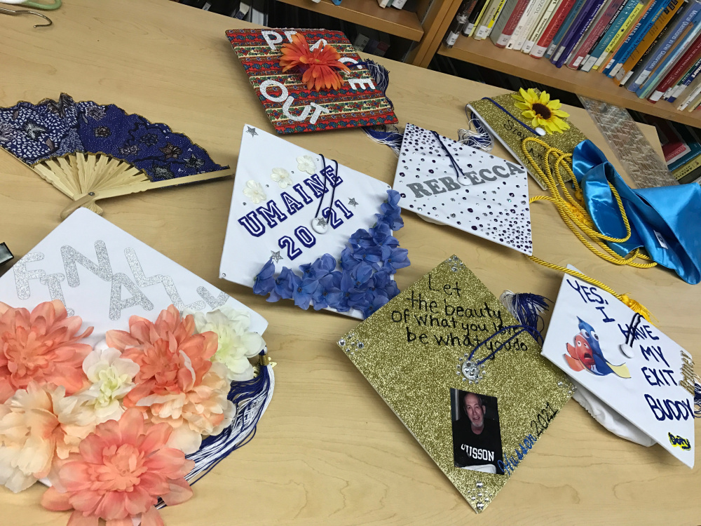 Some Mt. Abram graduates showed off their decorated mortarboards before commencement at Mt. Abram High School on Friday night.