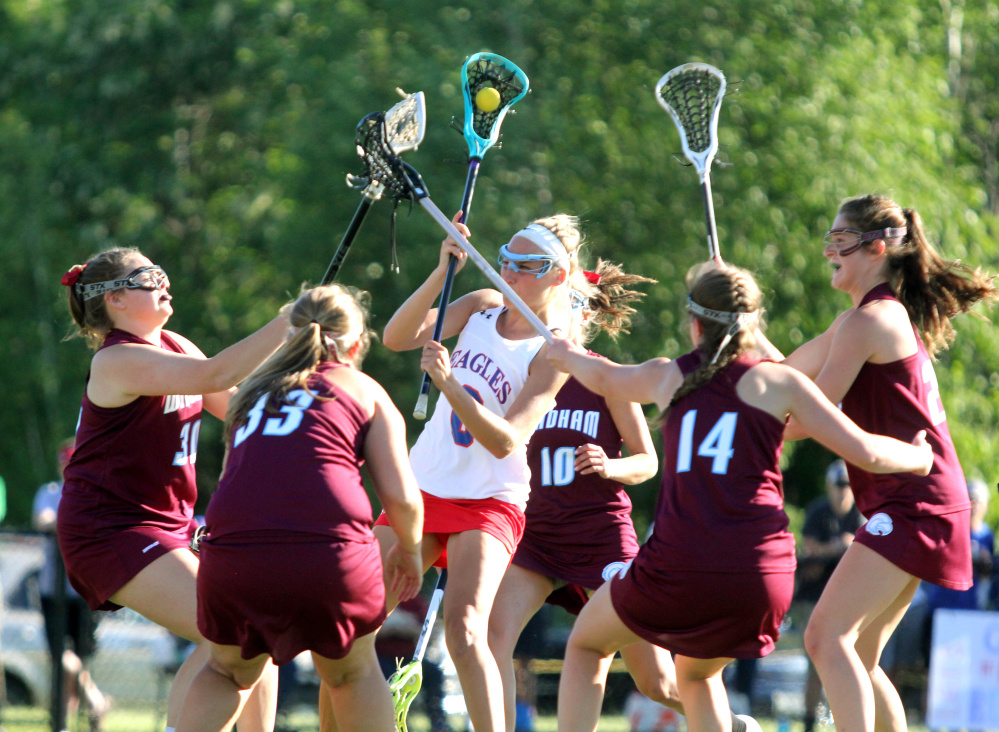 Messalonskee's Ally Turner tries to get a shot off as a host of Windham defenders converge in the first half of the Class A North championship game Wednesday at Thomas College.