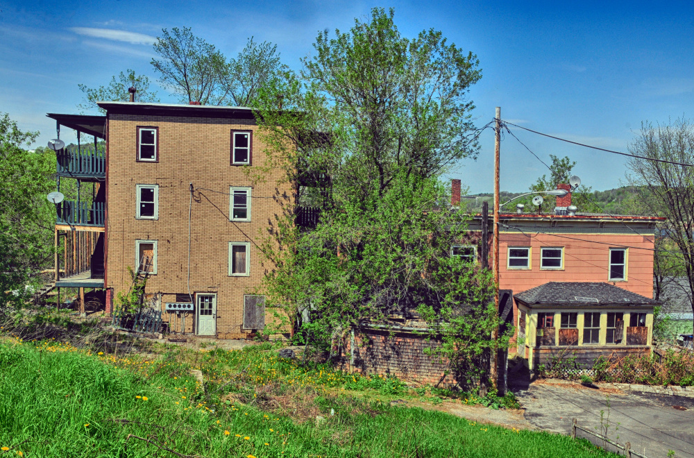 The city of Augusta plans to demolish 11 State Street, left, and 15 Morton Place in Augusta, shown May 18, to create a marketable building lot.