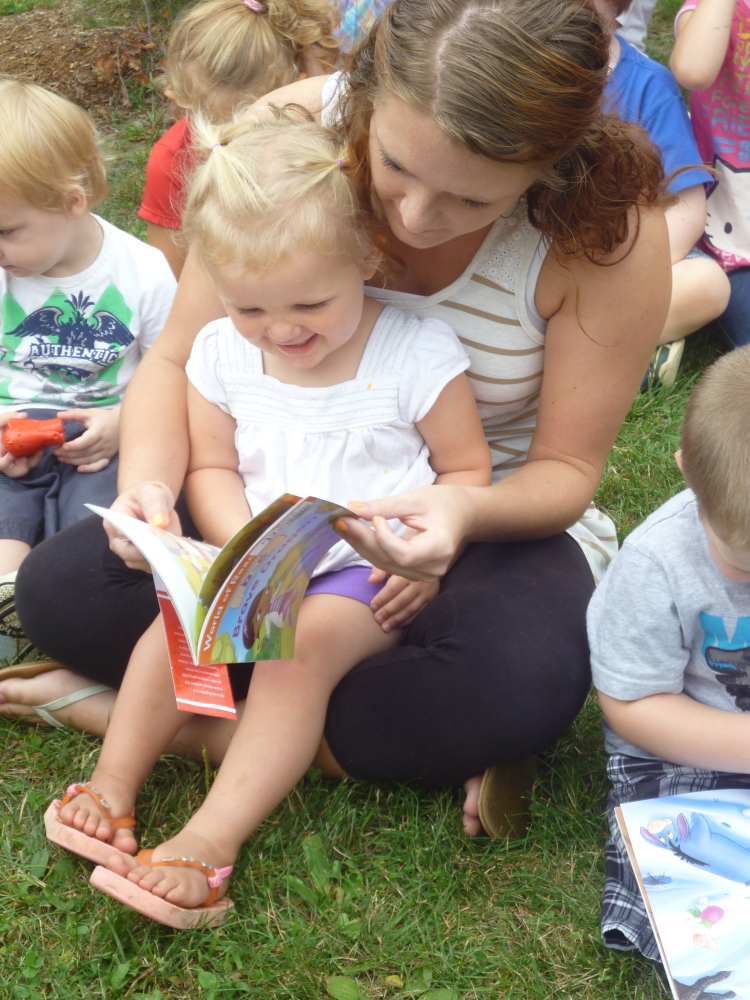 Charli Cote reads her new book with Educare staff member Leeannza Delosh in April 2015.