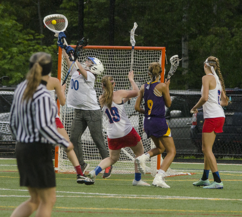 Messalonskee goalie Gaby Languet makes a save during a Class A North semifinal game against Cheverus atThomas College in Waterville