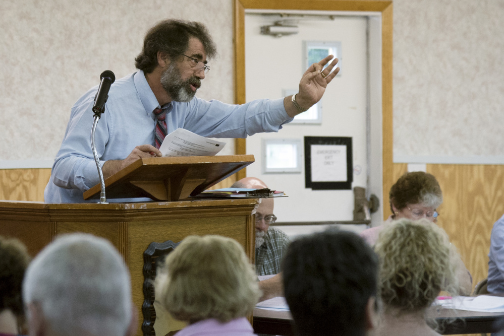 Moderator Earl Lamoreau gestures to make sure that voters understand the motion on the floor Saturday during Litchfield's Town Meeting.