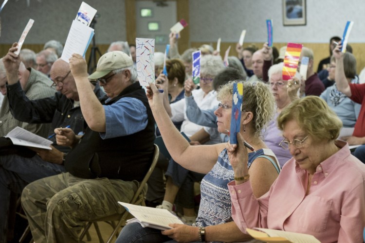 Resident Dick Cutliffe stands and speaks on Saturday during Litchfield's Town Meeting, held at the Sportman's Club.