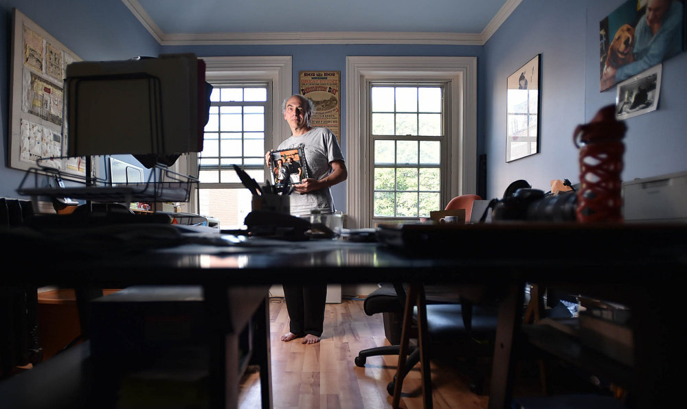 Maine International Film Festival programmer Ken Eisen poses Friday with a portrait of him and director Jonathan Demme in his MIFF office on Main Street in Waterville. Demme will be honored at the 20th annual Maine International Film Festival.