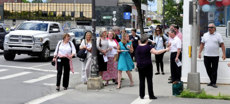 Waterville City Manager Mike Roy, second from right, leads members of the U.S. Environmental Protection Agency and others who toured downtown Waterville as well as local agencies that contribute to a healthy environment.