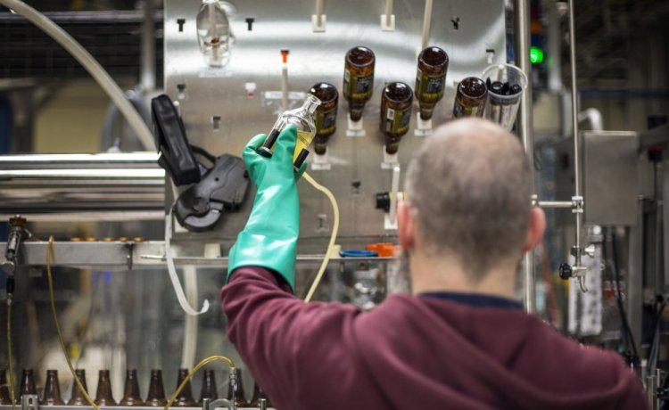 Rob Heater tests the carbonation of Tripel ale at Allagash Brewing Co. The quality of beer made by Allagash and others depends partly on wetlands and small streams that feed the systems from which their water is drawn.