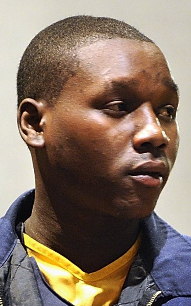 Gordon Chibroski/Staff Photographer 
 Moses Okot, 21, appears Friday in Cumberland County Superior Court with his temporary attorney, Joel Vincent. A police affidavit alleges that when Daudoit Butsitsi, 24, shot Serge Mulongo on Feb. 10 in Portland, Okot was the getaway driver and provided the shooter with latex gloves.