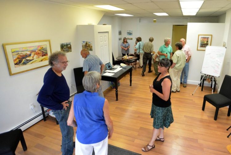 People gather at Skowhegan's newest art venue, Fourteen Madison, on Wednesday to plan for Wesserunsett Arts Council's annual Open Studio Tour, which will be held Aug. 12 this year, and not in October as in previous years.