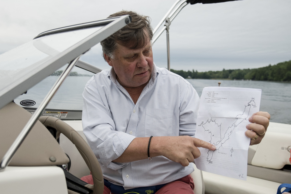 Norval "Tad" Garnett, a summer resident of China, points on Saturday to his family's assigned section of China Lake to find and count loons. This is Garnett's second year of participation in Maine Audubon's annual count.