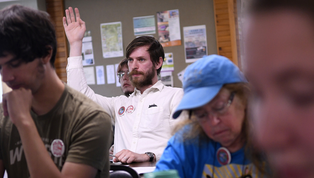 A member of the Socialist Party of Maine seeks to speak Sunday during a statewide meeting of socialists of Maine in Augusta.