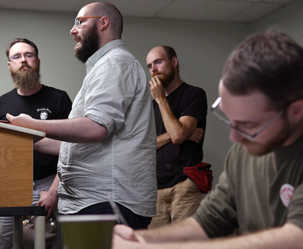 Maine Socialist Party member Jeremy Claywell, right, takes notes Sunday of a presentation by members of the Maine John Brown Gun Club during a statewide meeting of Maine socialists in Augusta. The Gun Club's Facebook page describes themselves as "the Maine branch of Redneck Revolt. We're anti-racist, anti-capitalist working folks working in solidarity for liberty for all people."