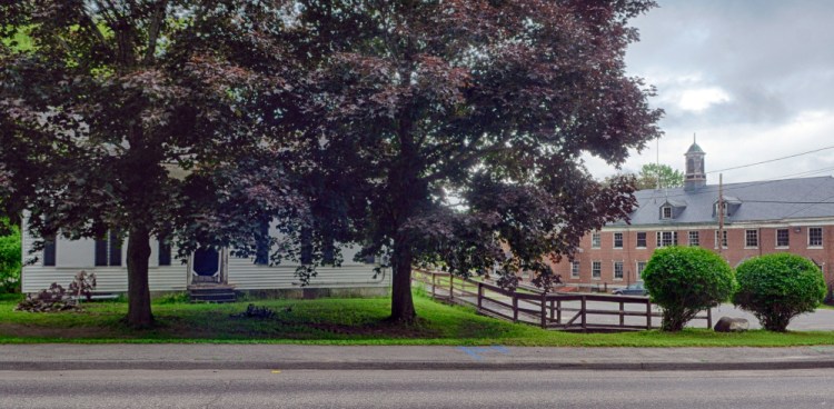 The Farwell Building, at left, stands in front of the Stevens Building on Tuesday on the Stevens Commons Campus in Hallowell. The Farwell Building is scheduled to be demolished to make way for a new fire station.