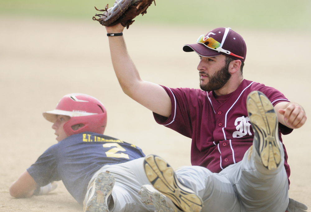 Augusta baserunner Taylor Heath, left, and Franklin first baseman Corey Rogers look to an umpire for a call after a rundown during a Zone 2 playoff game Tuesday at Morton Field in Augusta. Heath was tagged out sliding back into first.