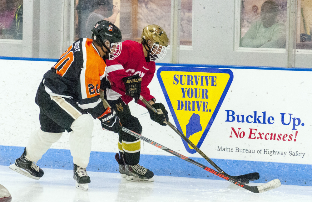 Gardiner's Tanner Hebert, left, and Cony's Zach Whitney battle for a puck during a summer league game Friday at the Camden National Bank Ice Vault in Hallowell.