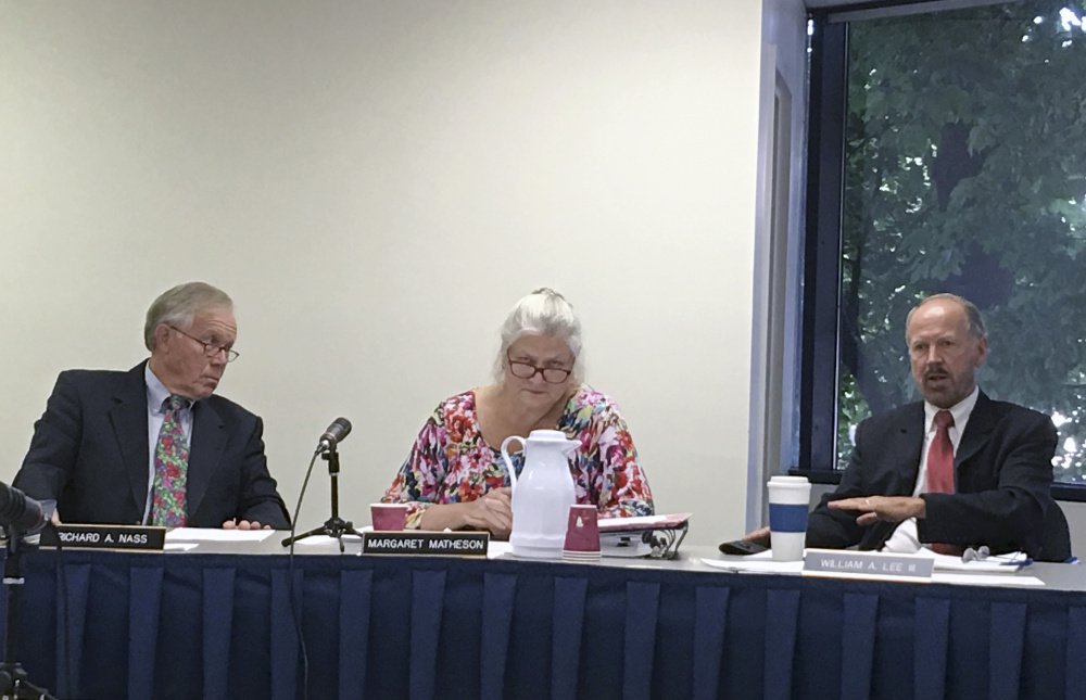 AUGUSTA, MAINE-August 10: Maine Ethics Commissioners Richard Nass, left and Margaret Matheson, center, listen as Commissioner William Lee, III, at right, discusses the commission's investigation into the finances of a ballot question campaign aimed at bringing a casino to York County Thursday at the commission's headquarters in Augusta. (Staff Photo by Scott Thistle/Staff Writer)