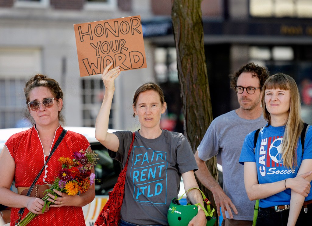 Gwendolyn Forrest, a Portland renter, holds up a sign during a rally at City Hall on Aug. 9 to push for a referendum in November on a rent stabilization ordinance. The City Council will hold a public hearing on the proposal Sept. 6. 