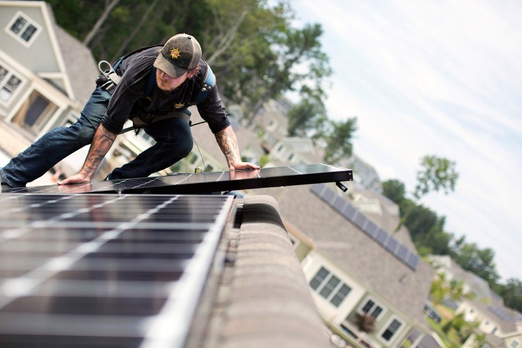 Jack Doherty of Revision Energy installs a solar panel Wednesday on a home at OceanView at Falmouth. The company, which employs almost 200 people, has installed panels on about 50 roofs in the development. A bill that died in the Maine House on Wednesday would have maintained incentives for solar installations and directed the Public Utilities Commission to study the costs and benefits of solar.