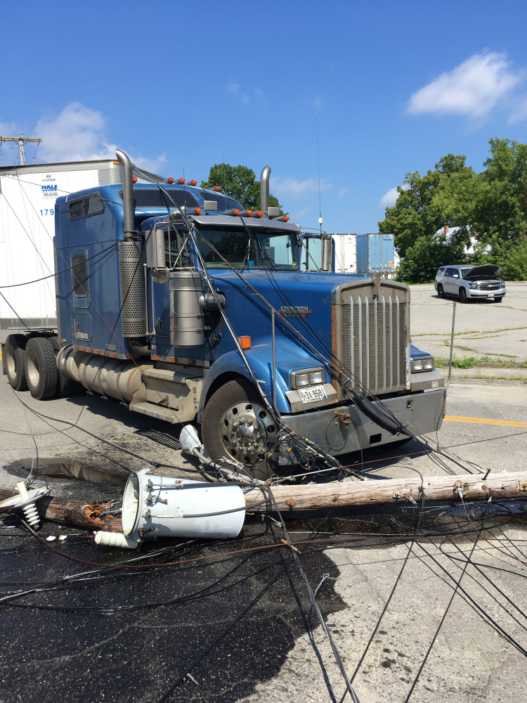 A tractor-trailer snagged power lines on Maple Street in Waterville, breaking two utility poles, sending a transformer crashing to the pavement and cutting power to about 280 Central Maine Power Co. customers.