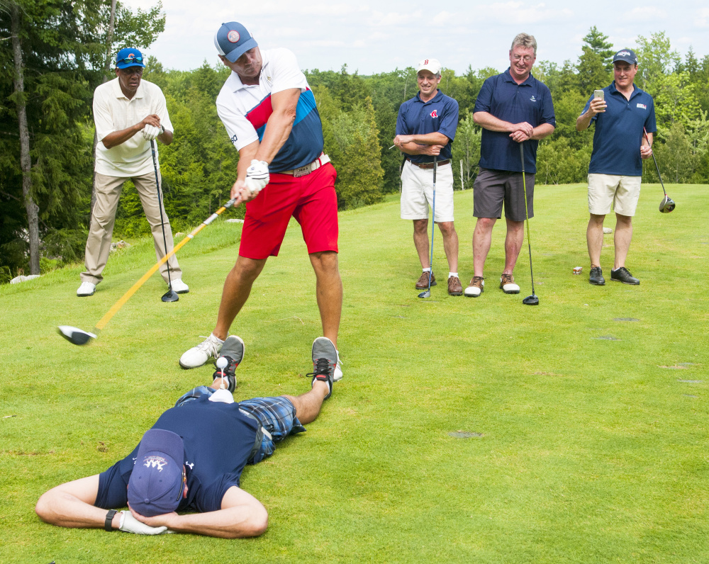 Fergie Jenkins, far left, watches as Rocky "Rockstar" Shipes, golf entertainer, professional longdriver, coach, and motivational speaker, second from left, hits a tee shot off Geoff Hixon, chief operating officer of the MLB Players Alumni Association, during the Ray Haskell Ford MLB Players Alumni Association golf fundraiser Thursday at Belgrade Lakes Golf Course in Belgrade. Shipes was driving around the course and joining each group for a hole. Other members in the group were Ken Walsh, John Bopreau and Mike Runser.