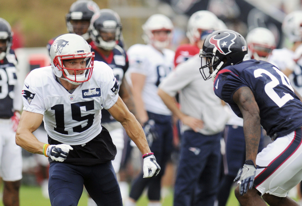 New England Patriots wide receiver Chris Hogan, left, runs past Houston Texans cornerback Johnathan Joseph during a joint practice Tuesday in White Sulphur Springs, West Virginia.