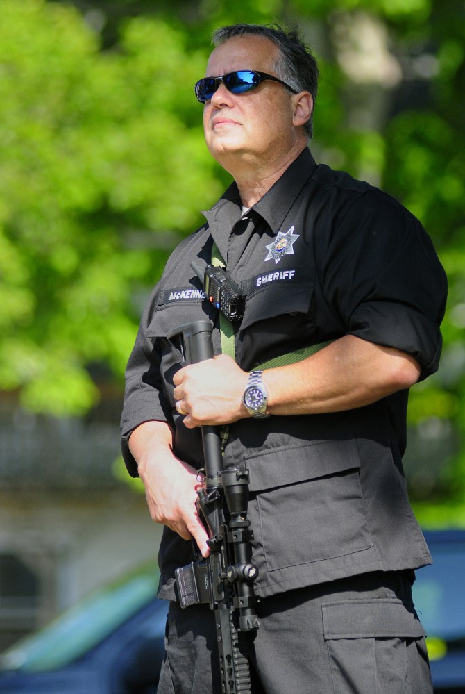 Kennebec County Chief Civil Deputy Harry McKenney stands guard at corner of State and Court streets during a drill Thursday at the Kennebec County Correctional Facility in Augusta.