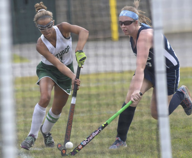 Winthrop forward Kinli DiBiasi, left, drives past Dirigo defender Devon Fletcher during a field hockey game Wednesday in Winthrop. The Ramblers won, 2-1.