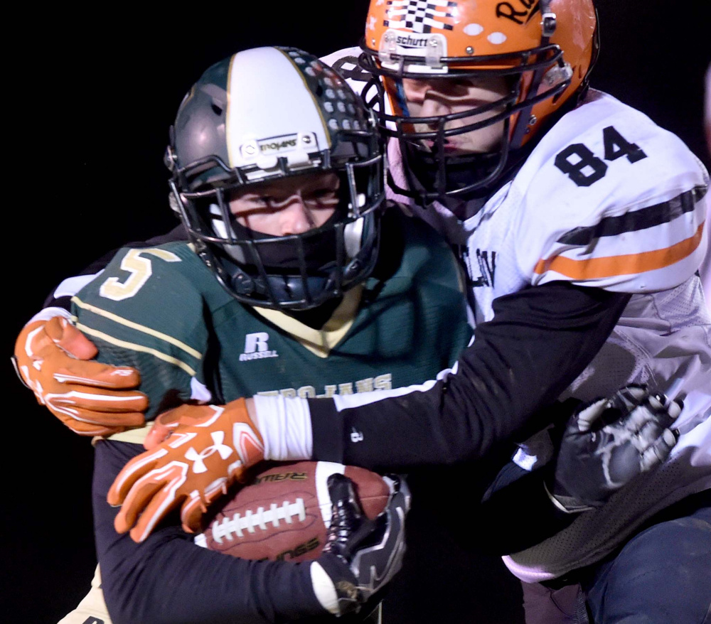 Winslow defensive end Hunter Campbell tackles Mount Desert Island running back Colby Lee during the Big Ten Conference championship game last season in Bar Harbor.