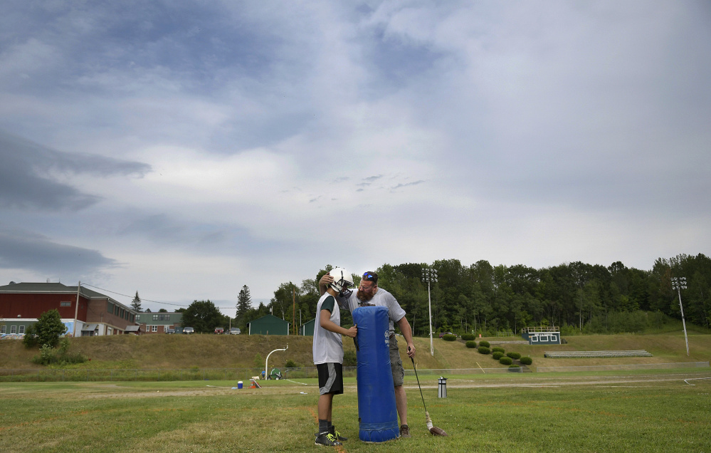 Winthrop/Monmouth assistant coach Todd Park confers with Noah Dunn during an Aug. 15 practice at Winthrop High School.